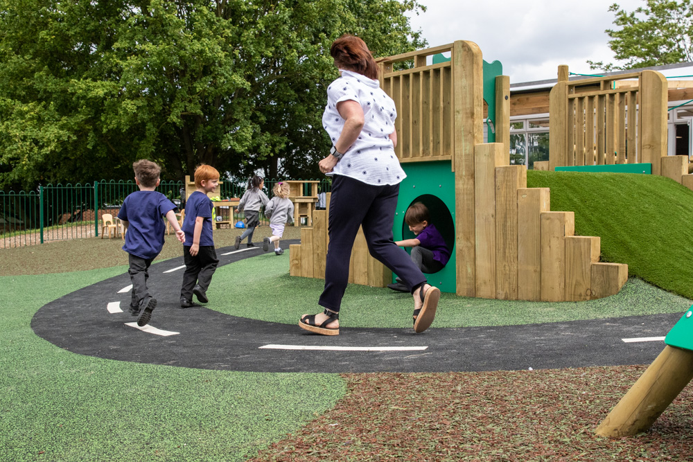 EYFS children running around soft play safety surfacing road design.