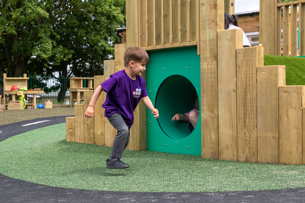 Young child playing with EYFS outdoor equipment. School Playground Design in Harrogate